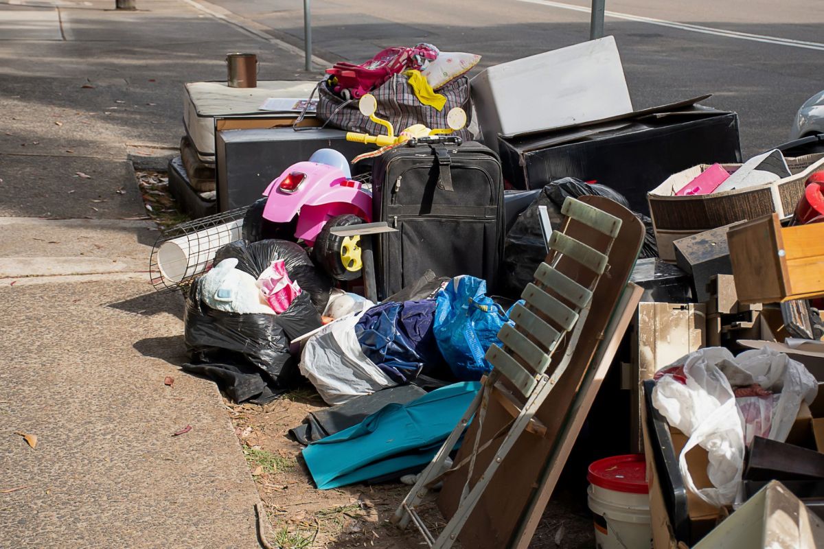A pile of household trash alongside a roadway.