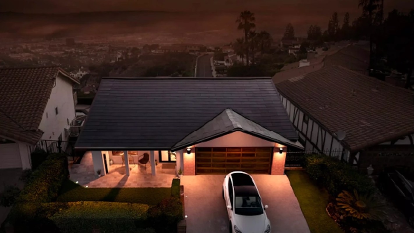 A modern house with a car parked in the driveway, surrounded by landscaped greenery.