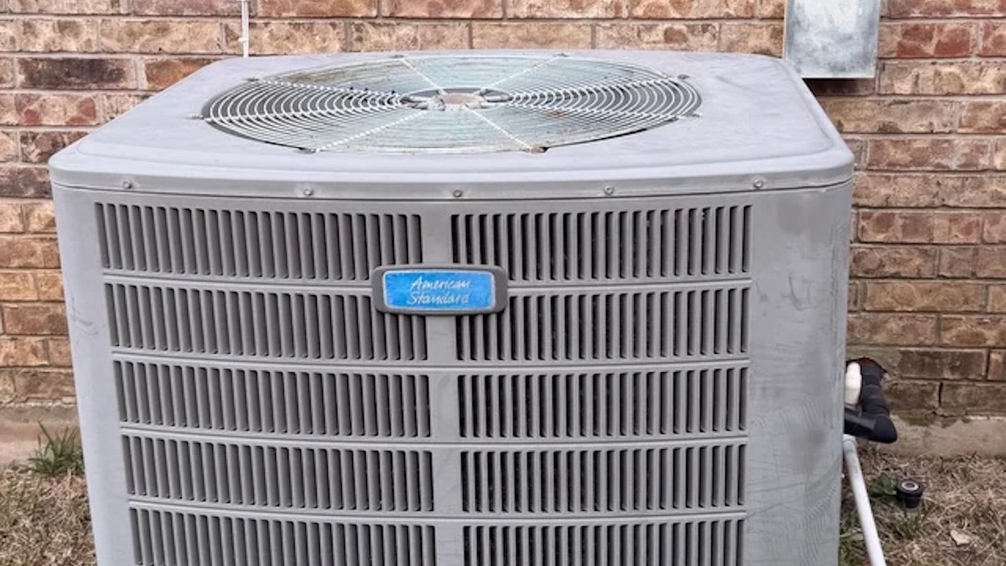 An outdoor air conditioning unit against a brick wall.