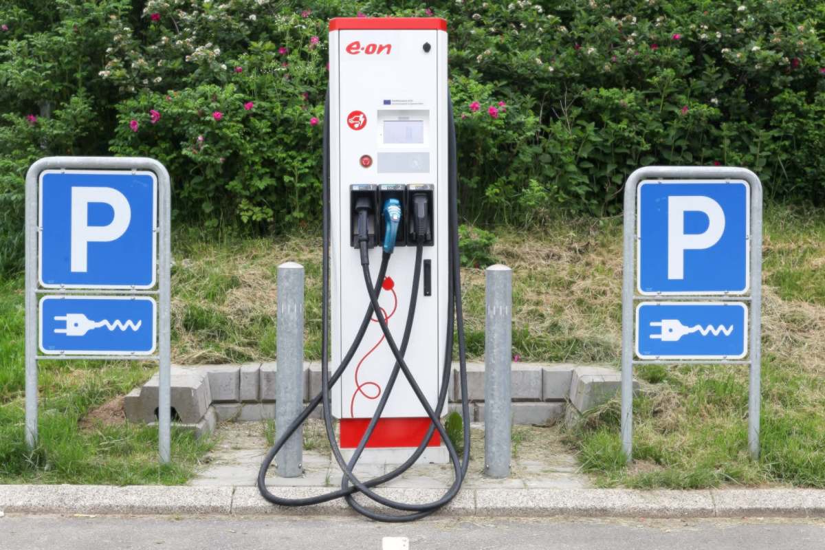 An electric vehicle charging station with two signage posts.