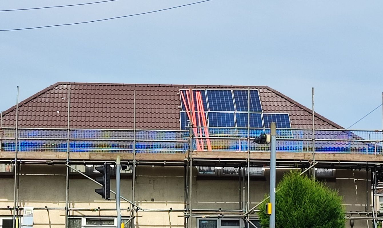 An unfinished solar panel installation on a roof.
