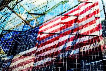 A reflection of an American flag on solar panels.