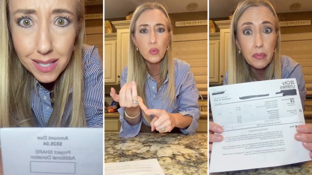 A woman holds a utility bill while showing a concerned expression in a kitchen setting.