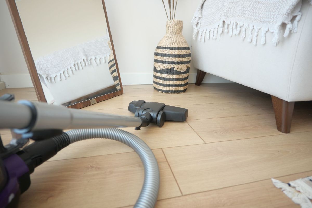 A wand vacuum on a wooden floor.