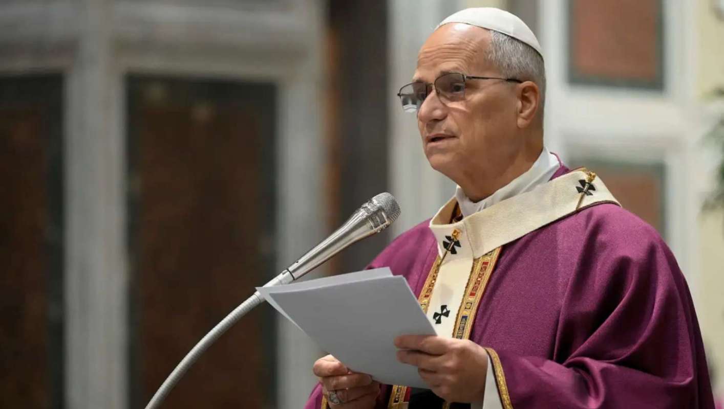 Pope Leo speaks at a microphone.