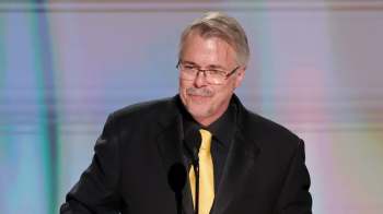 Vince Gilligan stands at a podium with a microphone.