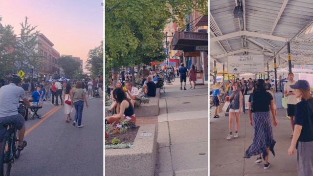 A bustling street scene with people walking, biking, and sitting at outdoor cafes.