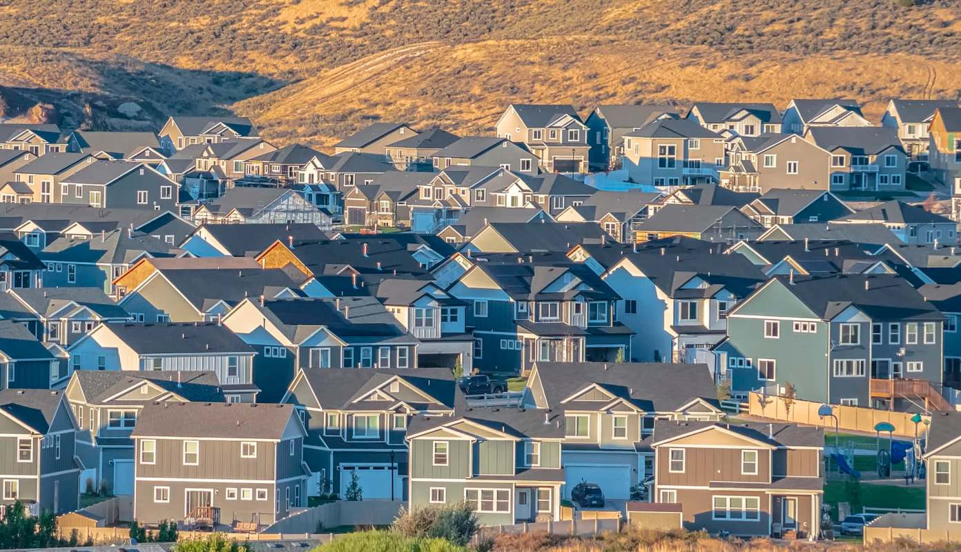 A residential neighborhood at the bottom of a hillside.