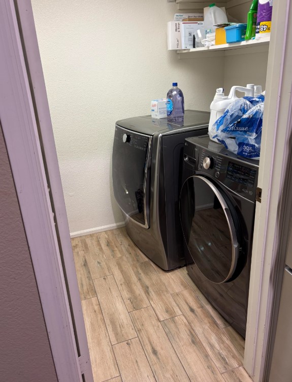 A small laundry room with a washer and dryer. 
