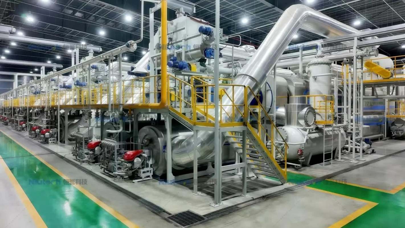 A large industrial facility with machinery, pipes, and staircases for processing.