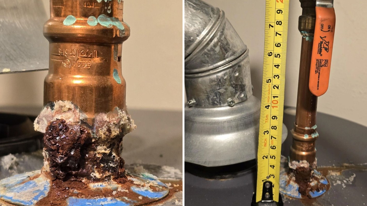Water heater pipes with corrosion and a measuring tape