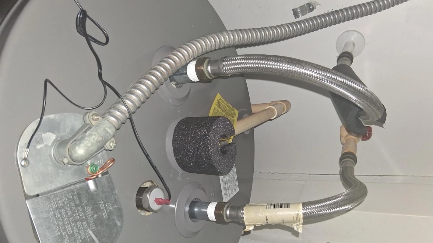 A close-up of plumbing connections for a water heater.