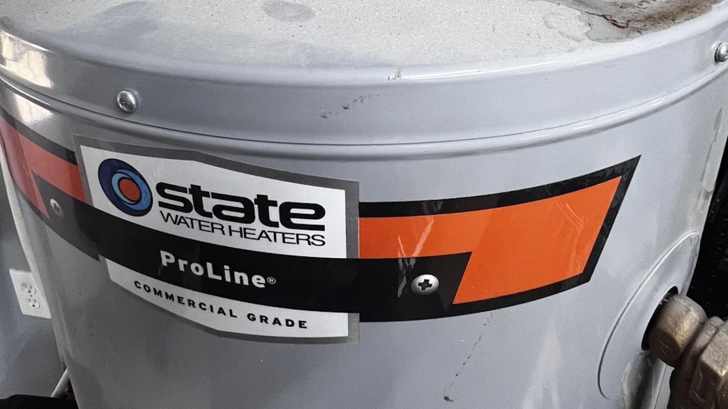A silver water heater with a label indicating it is a State ProLine commercial grade model.