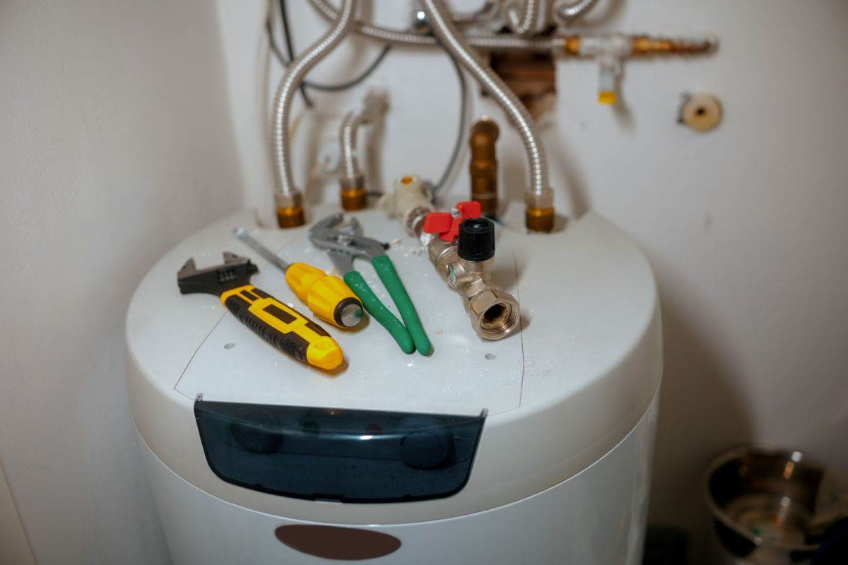 Tools on top of a water heater.