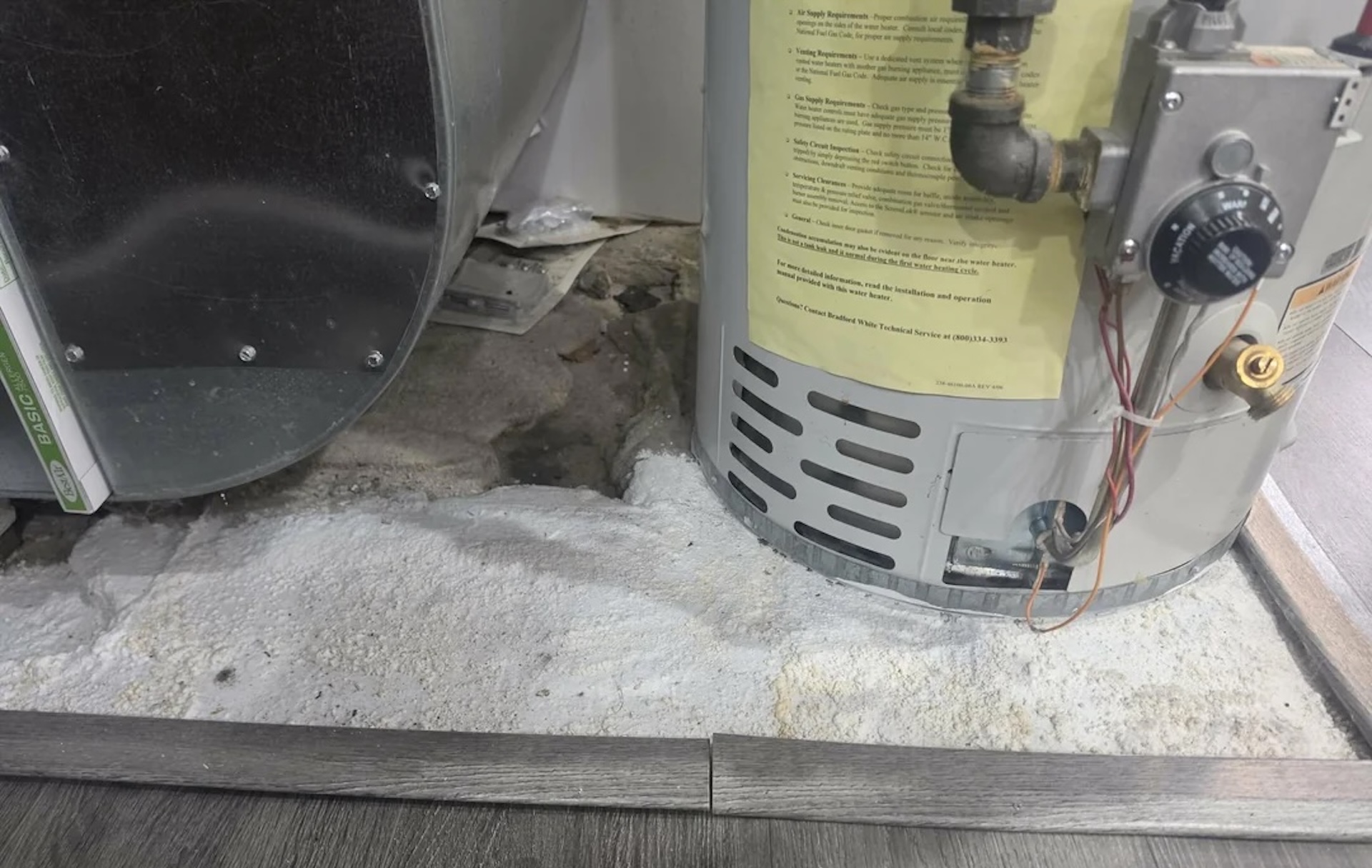 Homebuyer spots white buildup by water heater after realtor's moisture meter reads 80+