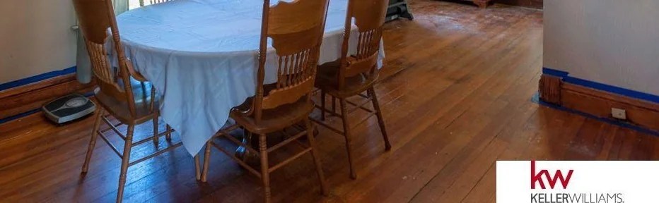 A dining room set on a hardwood floor.