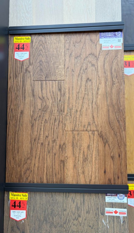 A wooden panel with sale stickers.
