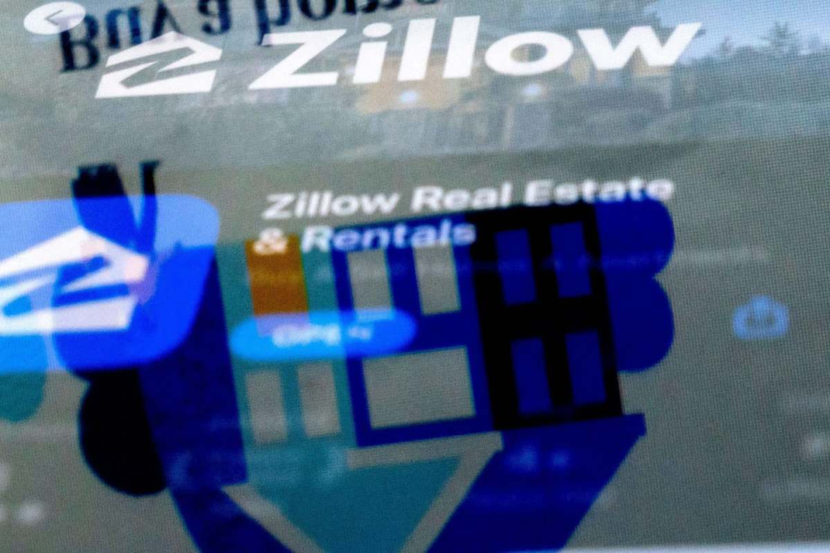 The Zillow website logo is reflected in the Zillow app and says Zillow Real Estate and Rentals