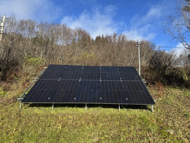 A solar panel array on a hillside.