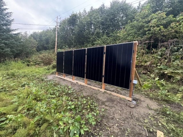 A solar panel array on a hillside.