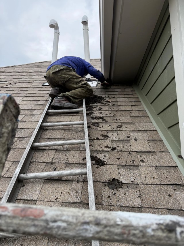A contractor fixing a roof.