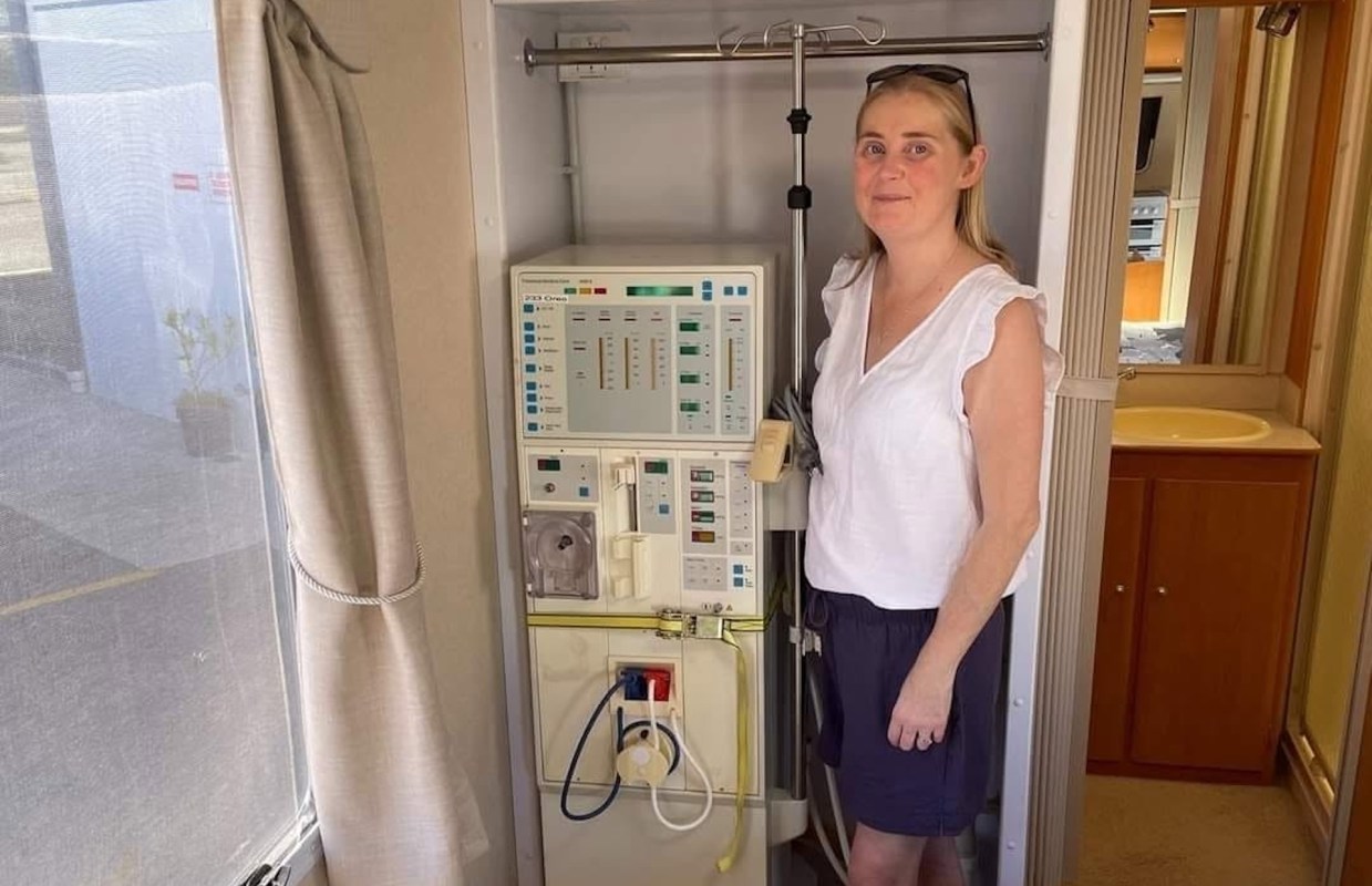 Claire Christie next to a dialysis machine.