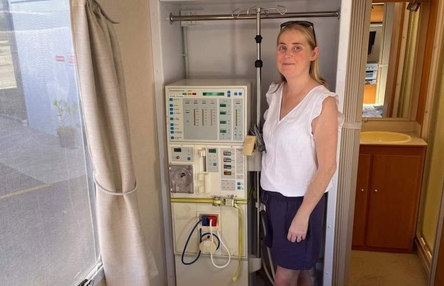 Claire Christie next to a dialysis machine.