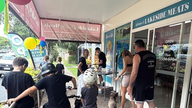 People outside Lakeside Meats for a sausage sizzle.