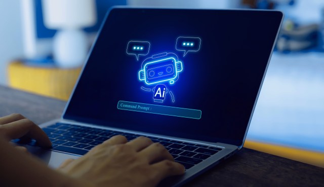 A person typing on a laptop with a glowing chatbot illustration on the screen.