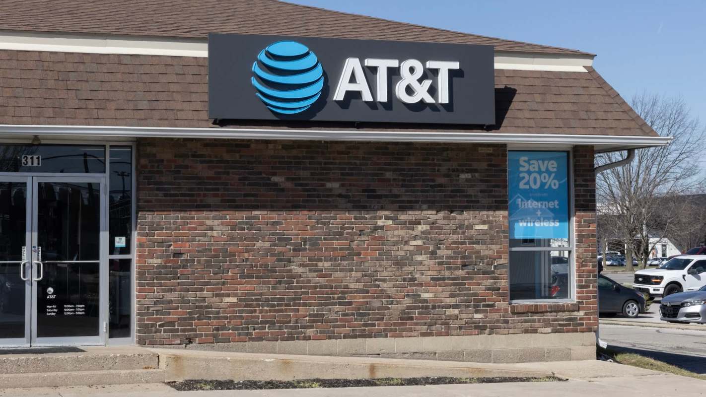 An AT&T store with a brick exterior and promotional signage advertising internet and wireless services.