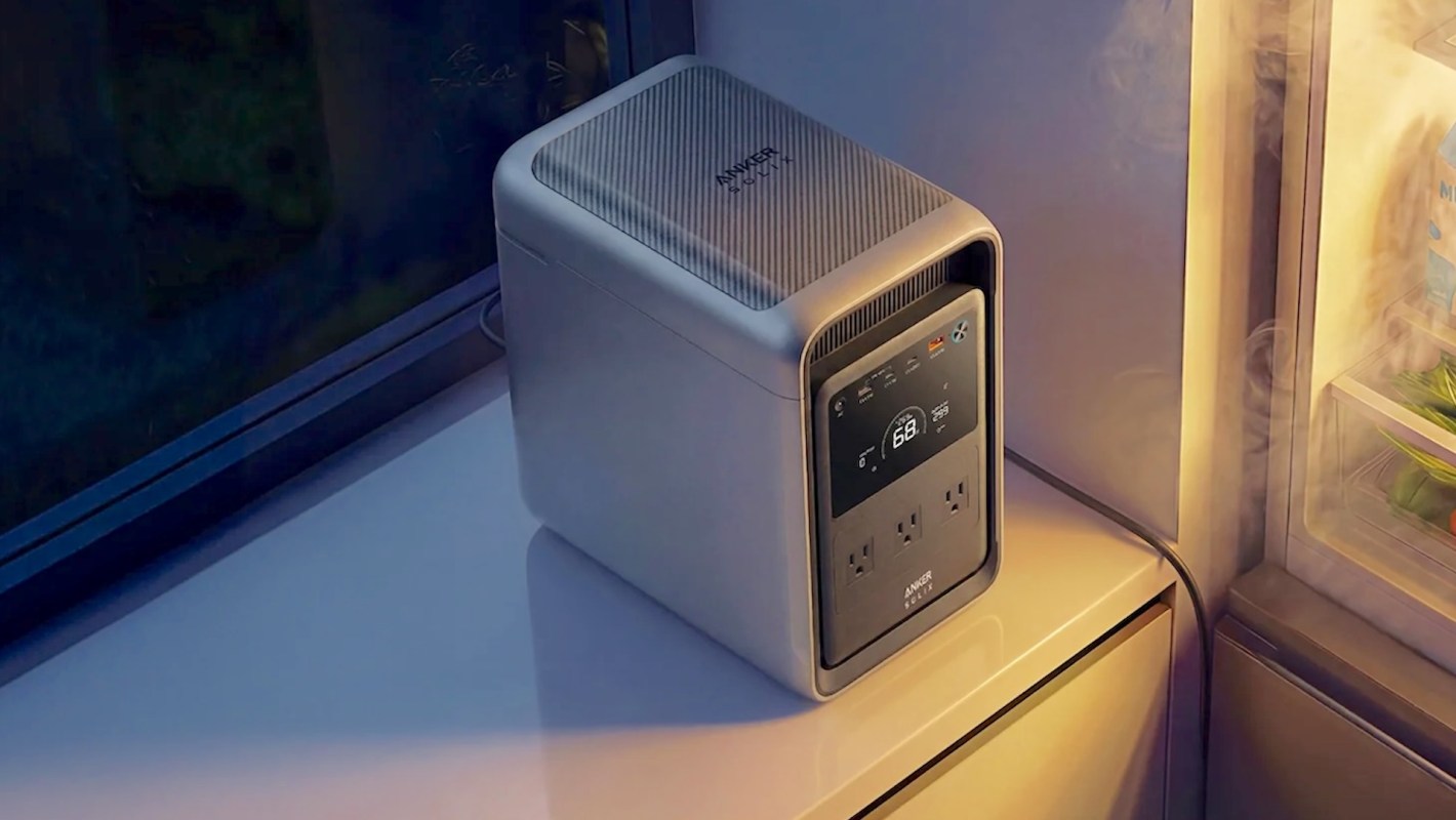 A compact power station positioned next to a refrigerator with visible steam and interior contents.