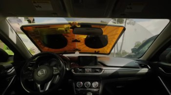 A Barnacle on top of a windshield as an alternative for car boots and towing.