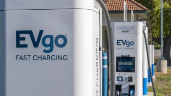 Two EVgo fast charging stations with charging cables in an outdoor setting.