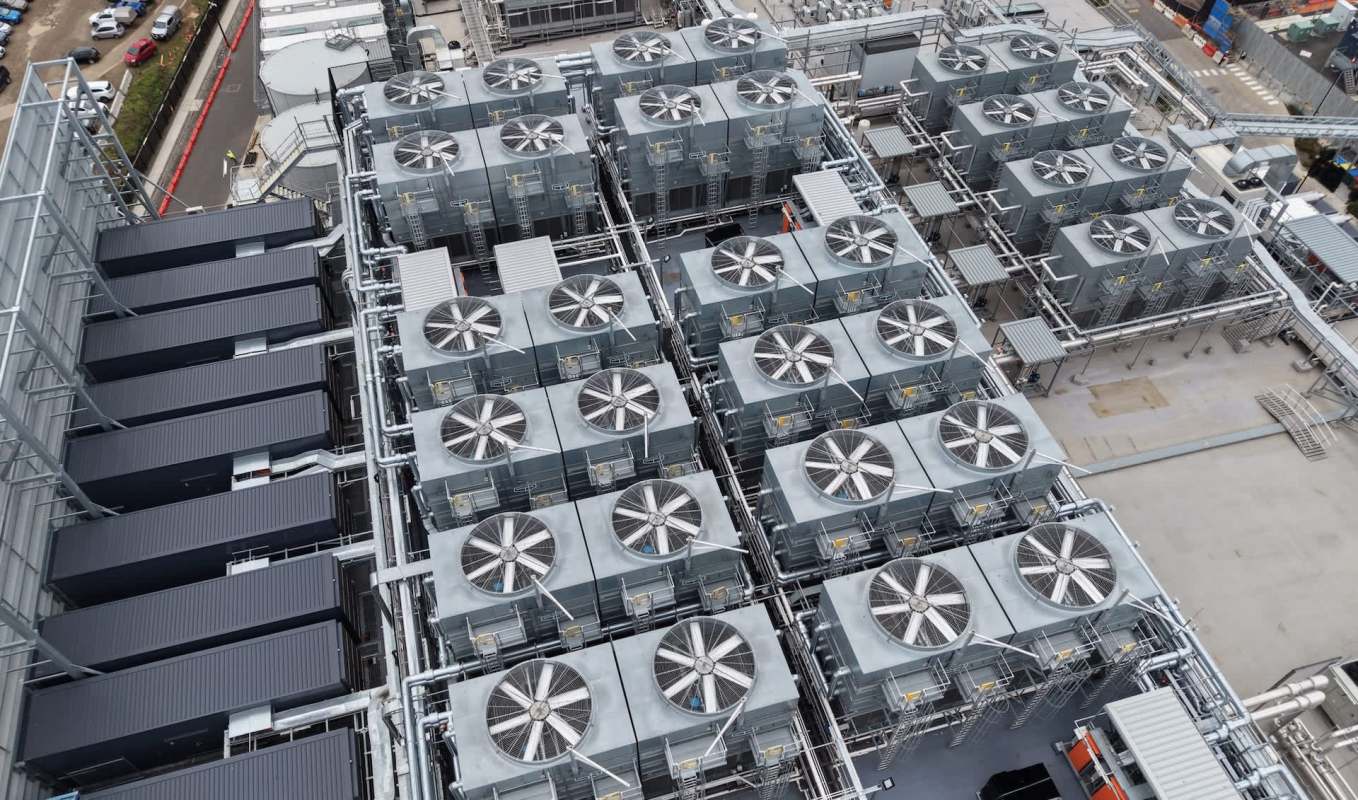 An industrial facility with large cooling units and connected piping.