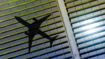 An airplane shadow over a solar farm.