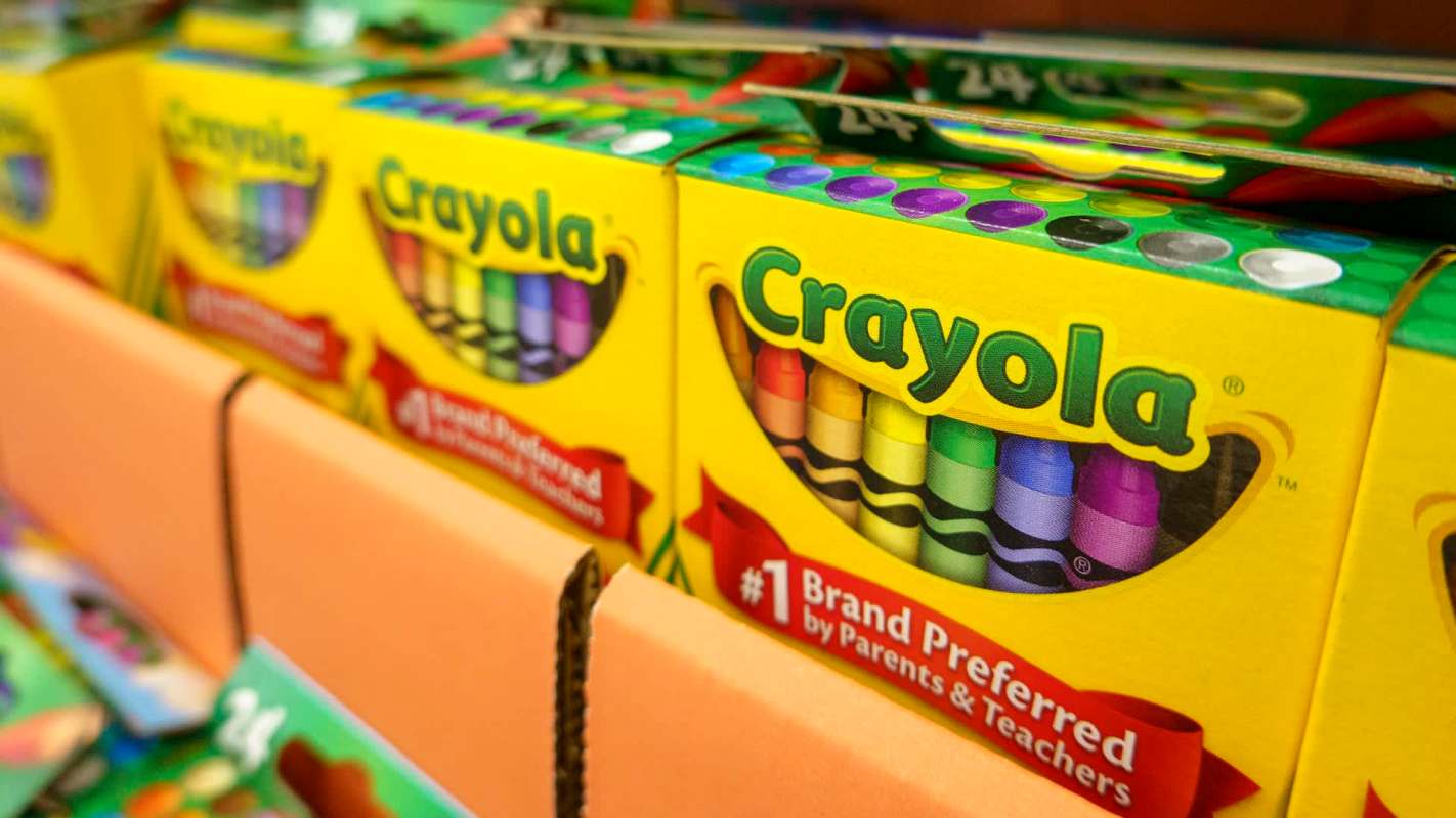 Boxes of Crayola crayons in various colors displayed on a shelf.