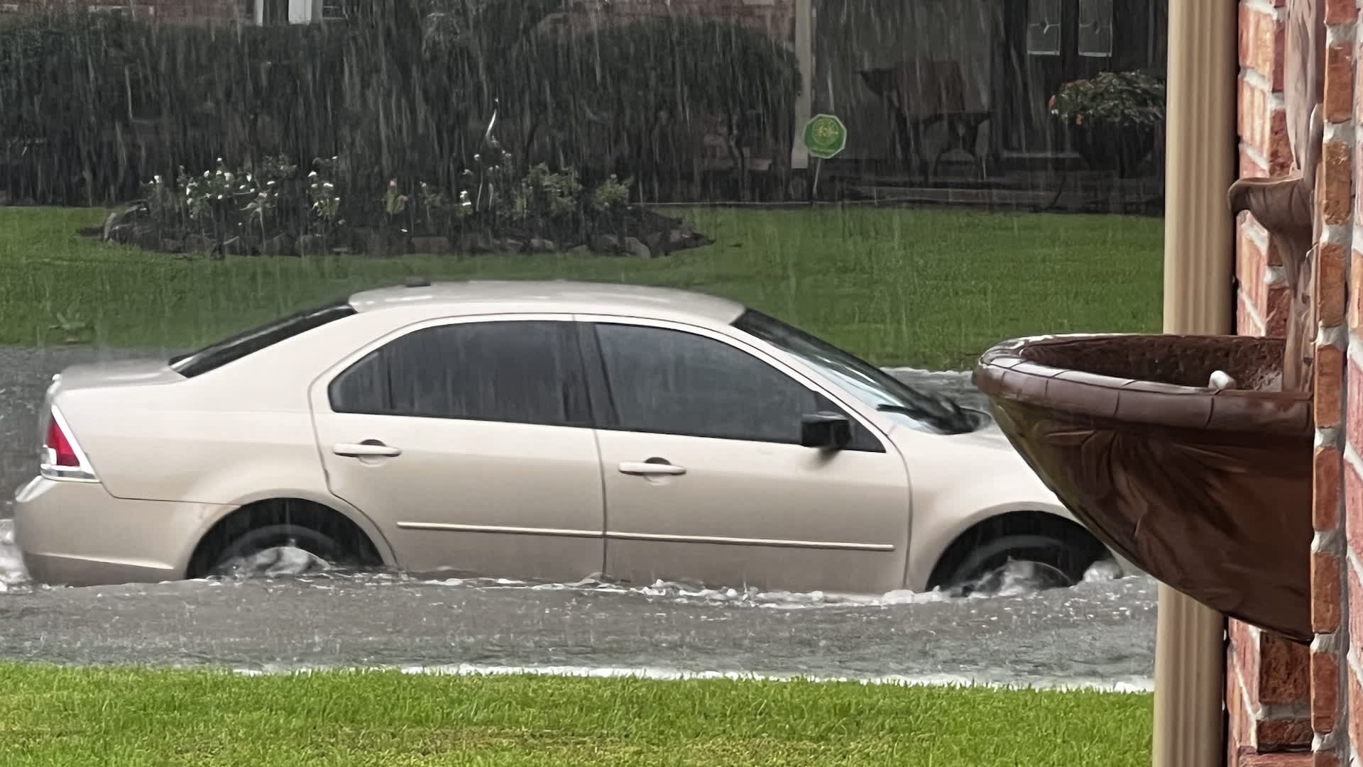 Texas storms wash out a water main, force 16 households out, and trigger a car rescue