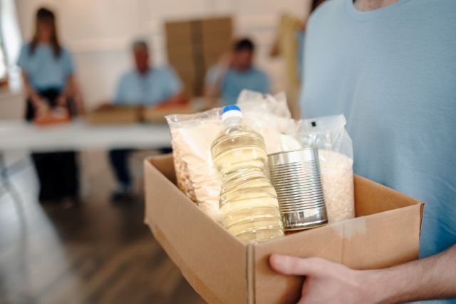 A person with a box of donations.