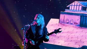 Phoebe Bridgers performs in concert in front of a set.