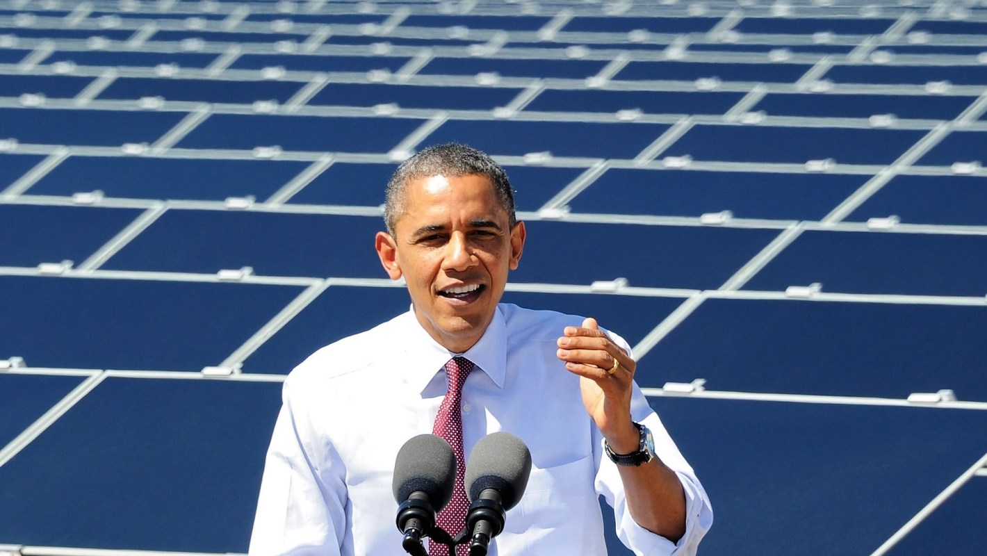 Barack Obama in front of solar panels.