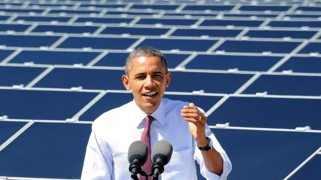 Barack Obama in front of solar panels.