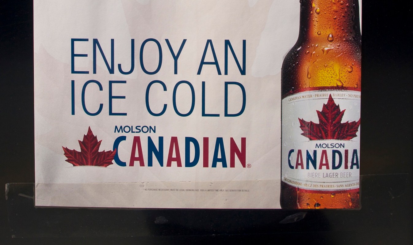 An advertisement for Molson Canadian beer featuring a bottle and the text "Enjoy an ice cold."