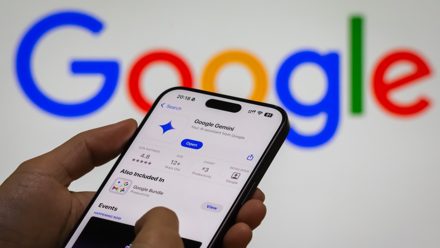 A person opening the Google Gemini app on their smartphone in front of the Google logo.
