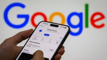 A person opening the Google Gemini app on their smartphone in front of the Google logo.