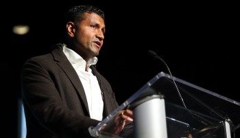 Palantir chief technical officer Shyam Sankar stands at a podium while speaking into a microphone.