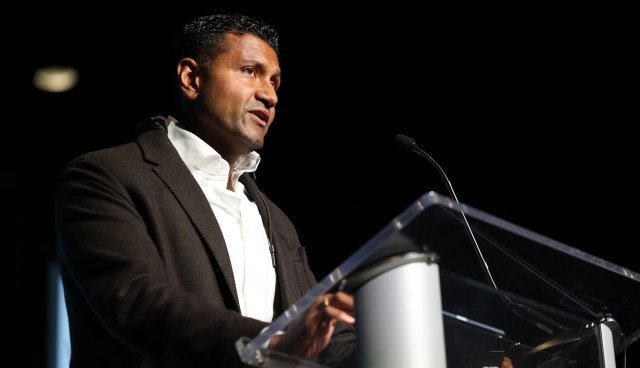 Palantir chief technical officer Shyam Sankar stands at a podium while speaking into a microphone.