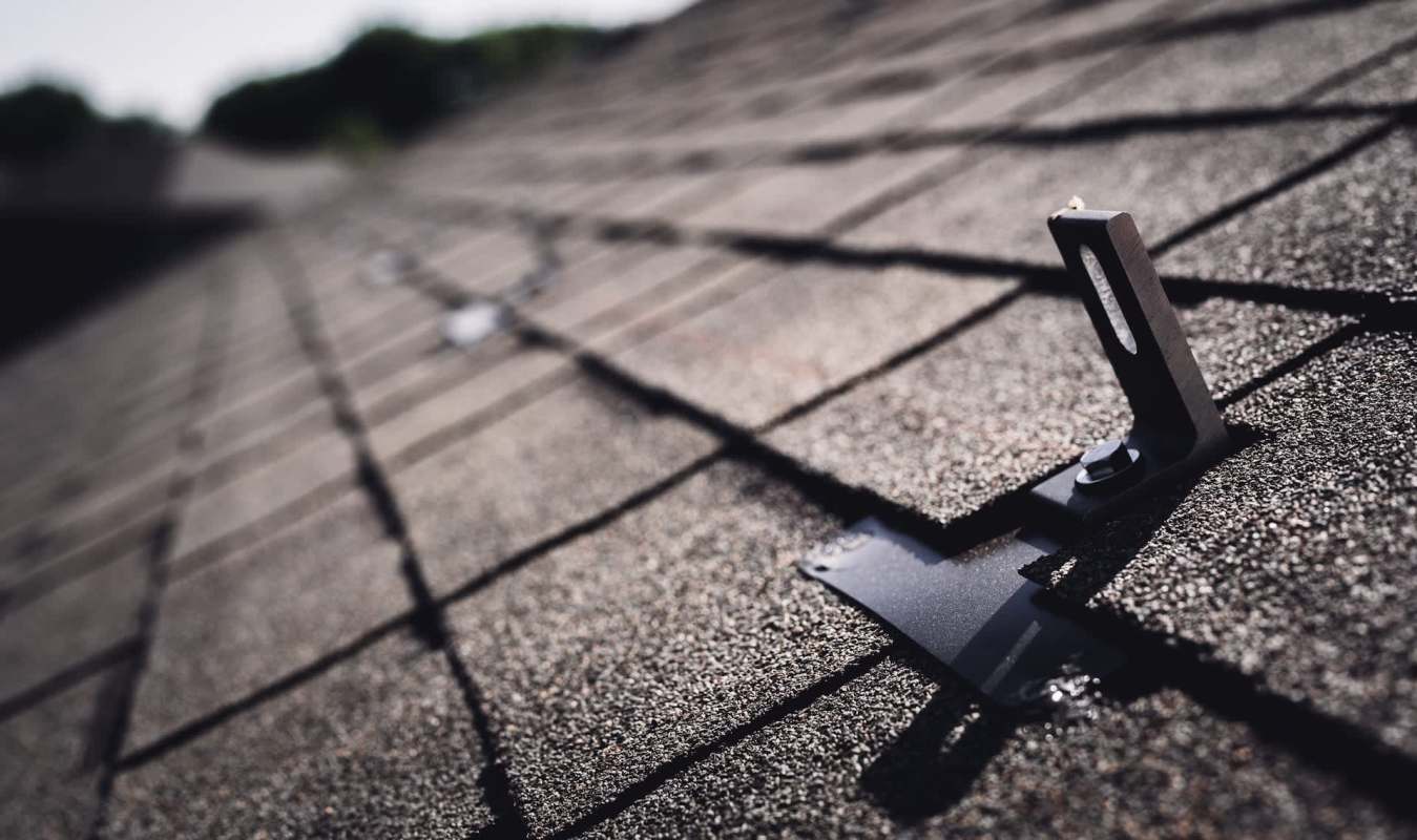 A metal attachment for solar panels on a roof.