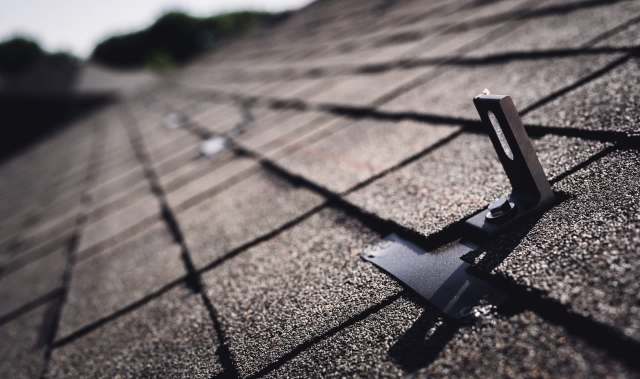 A metal attachment for solar panels on a roof.