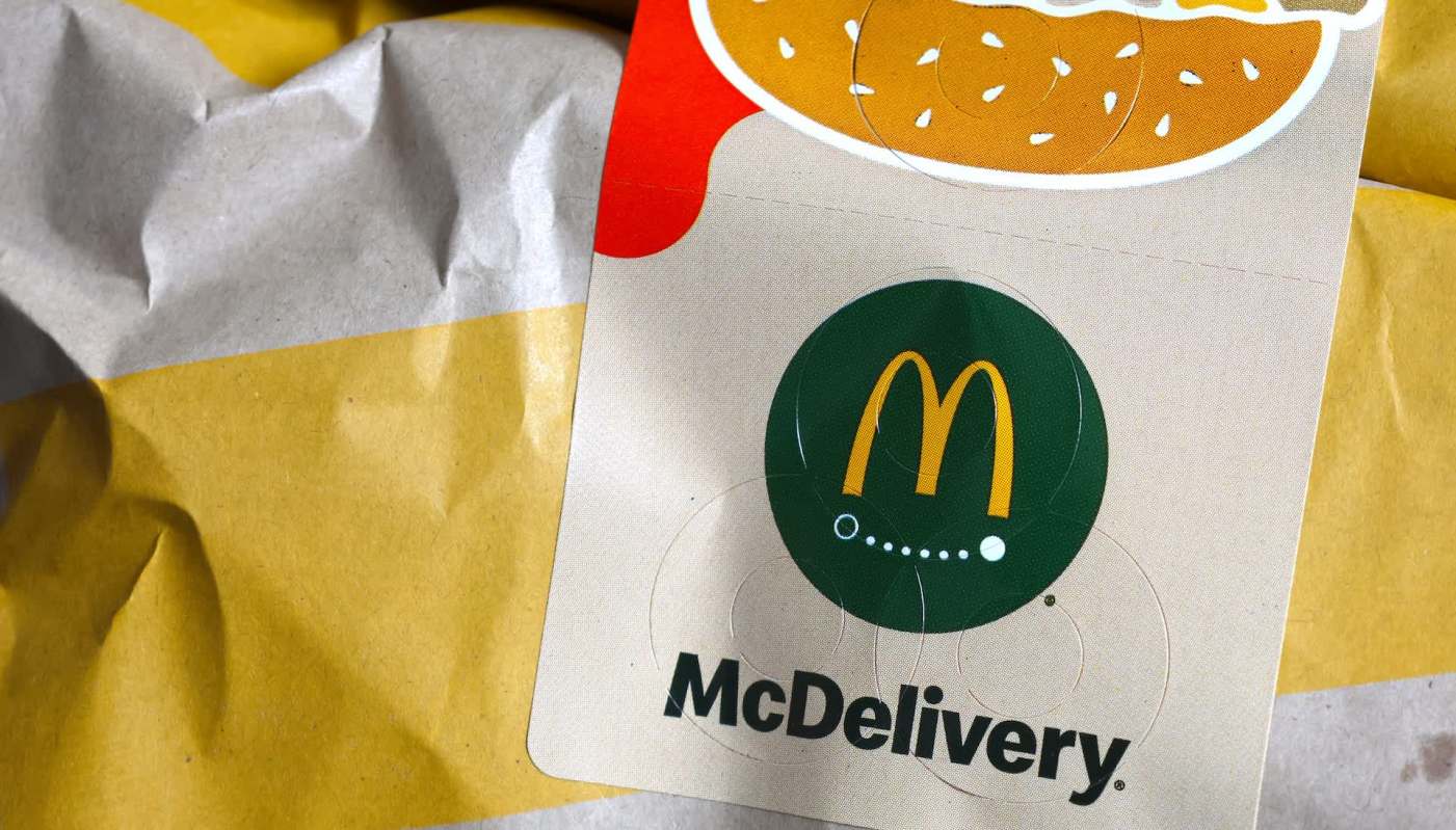 A McDonald's delivery bag with the McDelivery logo and food graphics.