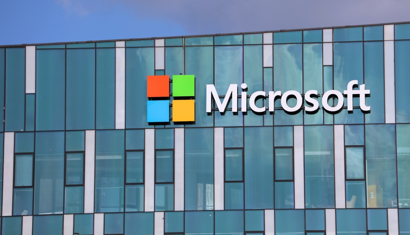 A Microsoft logo displayed on a modern glass building.